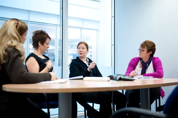 CHKS Accreditation - people around a table